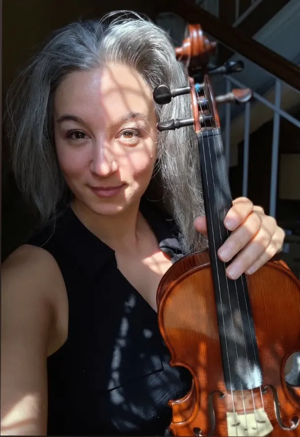 Alexandra holding her violin